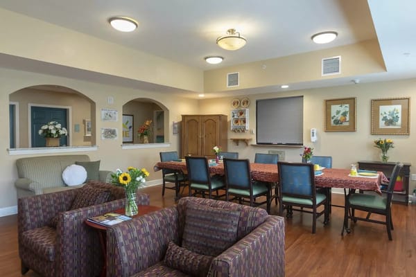 Bright common area with dining tables and chairs