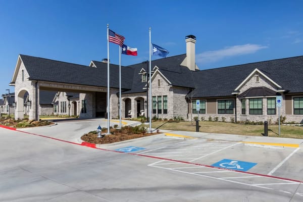Exterior view of Briarview Senior Living with flags