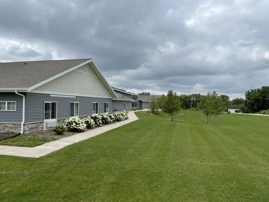 Exterior view of the assisted living facility with green lawn