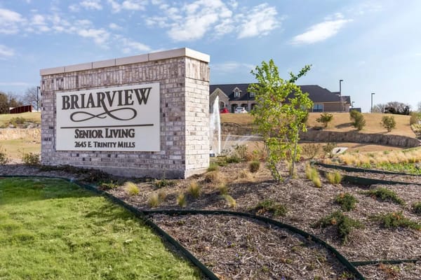 Exterior view of Briarview Senior Living sign and landscaping