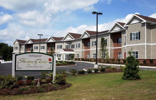 Exterior view of Memory Garden senior living facility showing the entrance and landscaping.