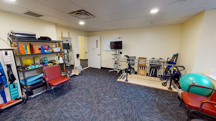 Interior view of a therapy room with exercise equipment