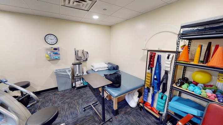 Rehabilitation room with therapy equipment and seating