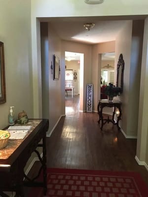 A hallway featuring a 'Welcome' sign and decorative elements.