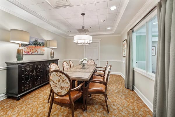 Bright common area with a dining table and chairs