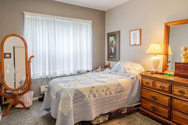 Cozy interior room with a bed and mirror