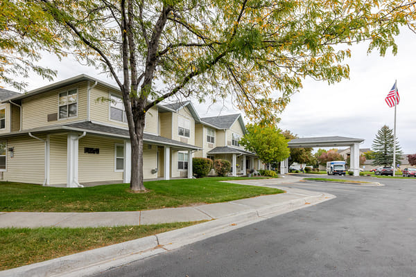Exterior view of the assisted living facility with trees