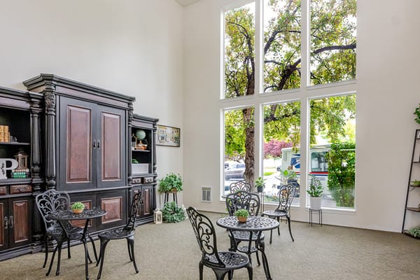 Bright common area with seating and large windows