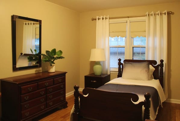 Cozy private room with a bed and dresser