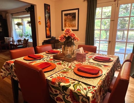 Dining area set up for a meal with colorful decorations