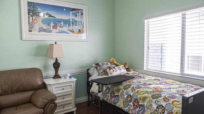 Cozy resident room with a bed and a chair