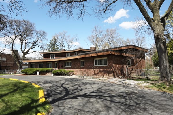 Exterior view of a senior care facility surrounded by trees