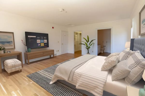 Well-decorated private resident room with a large TV