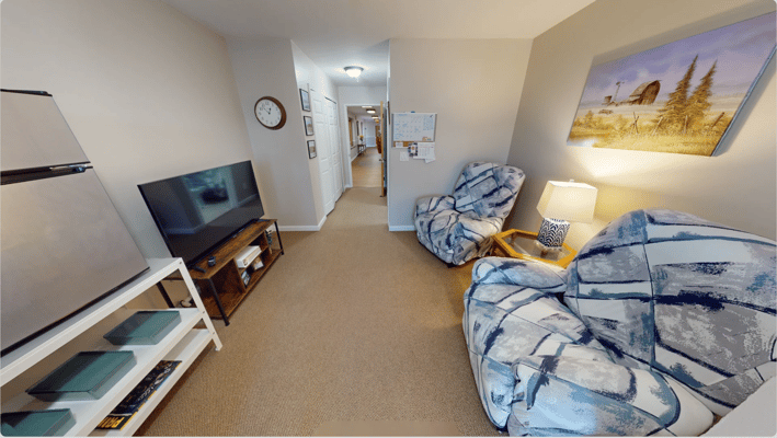 Cozy interior of a private resident room with seating