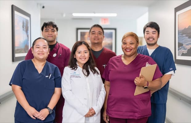 Staff members posing in a hallway at the facility