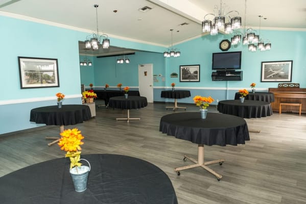 Bright common area with tables and flower arrangements