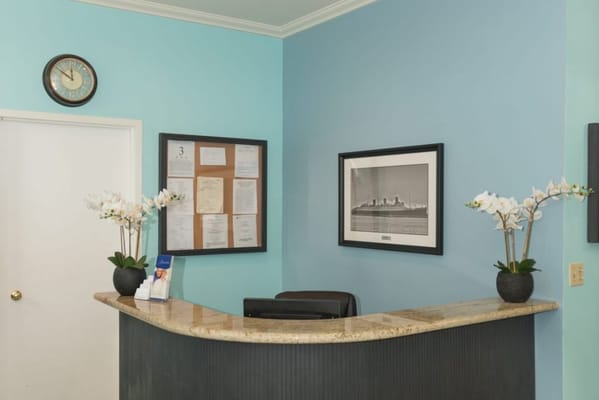 Reception area with a desk and wall decor