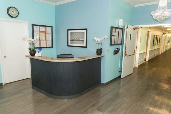 Reception area with a front desk and hallway