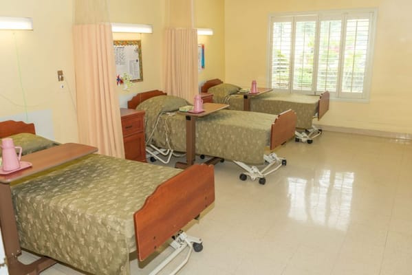 Shared resident room with beds and personal items