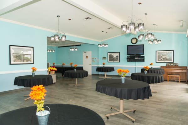 An interior view of a common area with tables and flowers