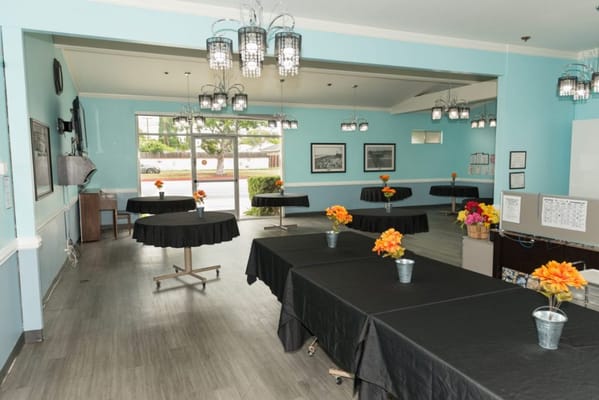 Bright common area with tables and flower arrangements