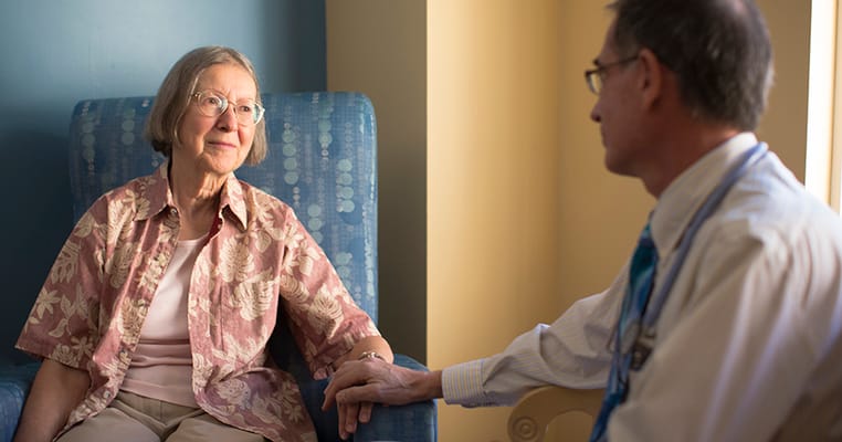 A resident and doctor engaged in conversation
