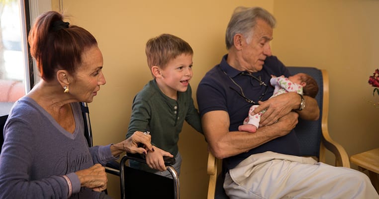 Residents interacting with family members in a cozy setting