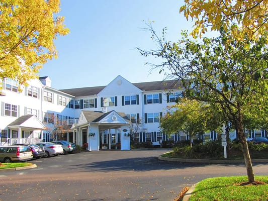 Front view of Pines Senior Living Community with autumn foliage