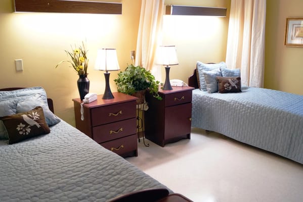 Cozy resident room with twin beds and lamps