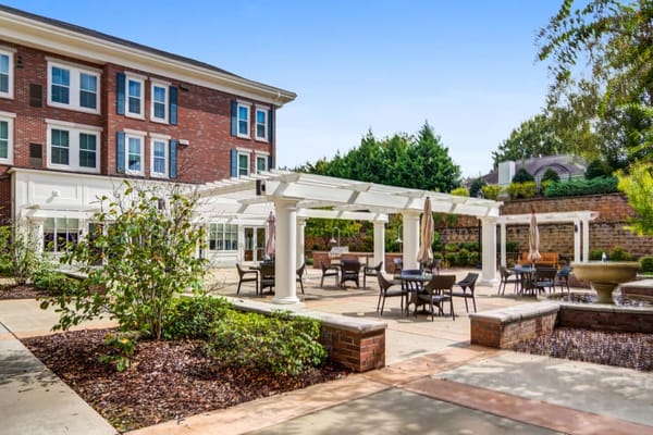 Outdoor seating area with pergola and landscape