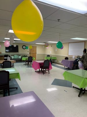 Interior view of a festive common area with balloons