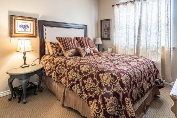A cozy bedroom with decorative bedding and natural light