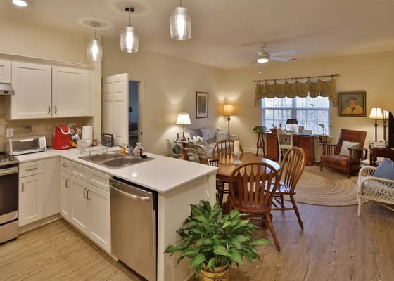 Bright common area with dining table and chairs