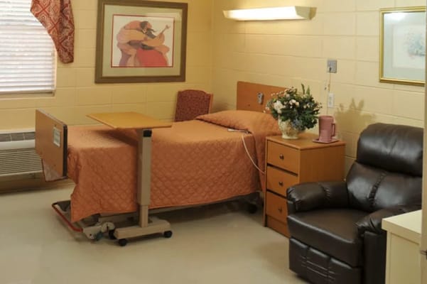 Private resident room with a bed and recliner