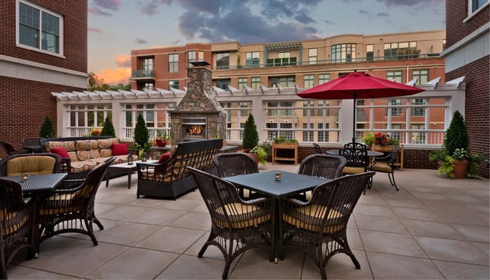 Patio area with seating and a stone fireplace
