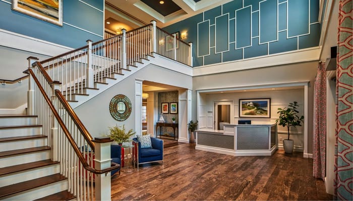 Spacious lobby with a staircase and seating area at Stone Hill at Andover
