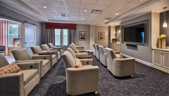 Comfortable seating in a modern media room with a large TV