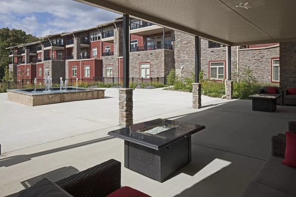 Outdoor patio with seating and fountain at The Summit