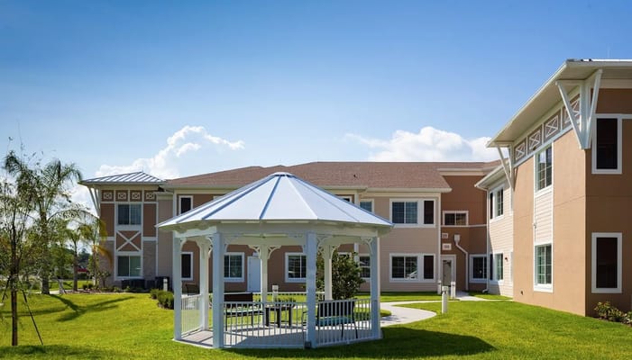 Exterior view of a senior living facility with gazebo