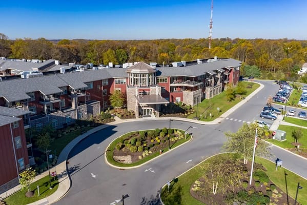 Aerial view of The Summit senior living facility showing entrance and landscaping.