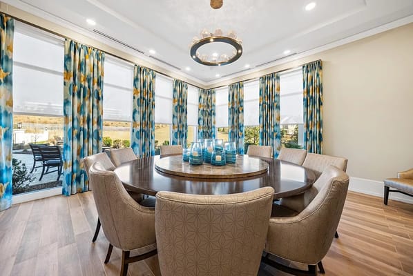 Cozy dining room with a circular table and colorful curtains