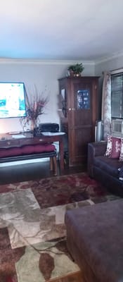 Cozy living room featuring a sofa, coffee table, and television.