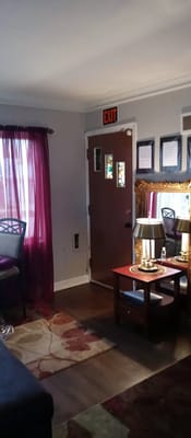 Living room with a door marked EXIT and a mirror table.