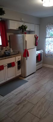 Bright kitchen featuring a refrigerator, stove, and vibrant decor.