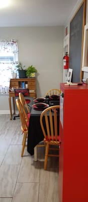 Dining table set with black tablecloth and red dishes