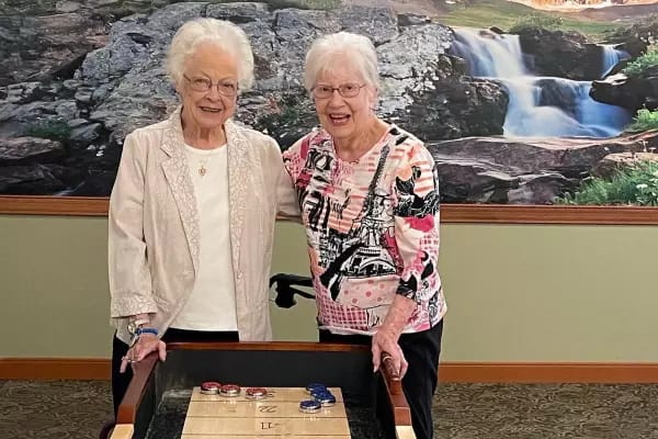 Two residents playing a game in a common area