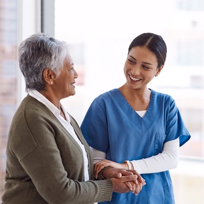 Caregiver smiling and chatting with a resident
