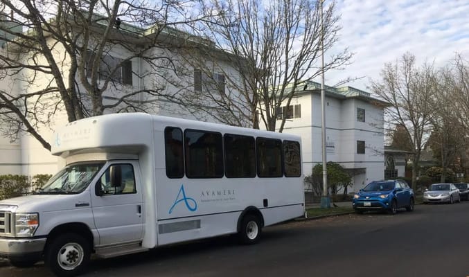 Facility transport bus parked in front of the building