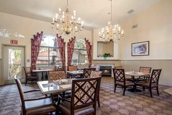 Elegant dining area with chandeliers and tables