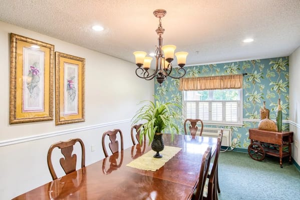 Bright dining room with floral decor and dining table